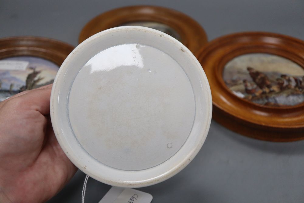 Three Prattware pot lids in oak frames and another Prattware pot